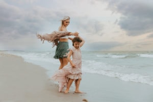 Fort Lauderdale Family Photographer, mother and child walking hand in hand on the beach