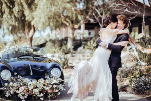 Fort Lauderdale Wedding Photographer, couple hugging next to getaway car