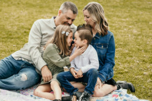 Fort Lauderdale Family Photographer, family of 4 sitting together in the grass