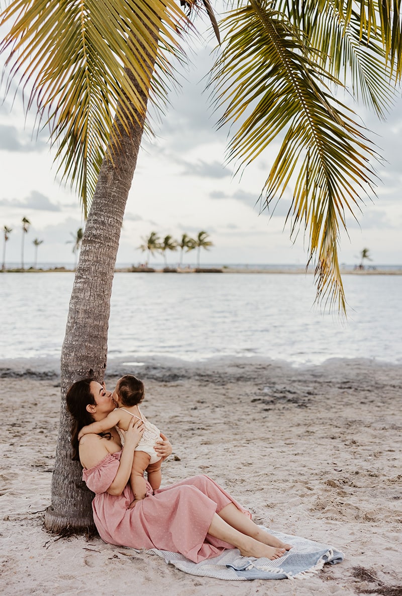 mom and baby under palm tree