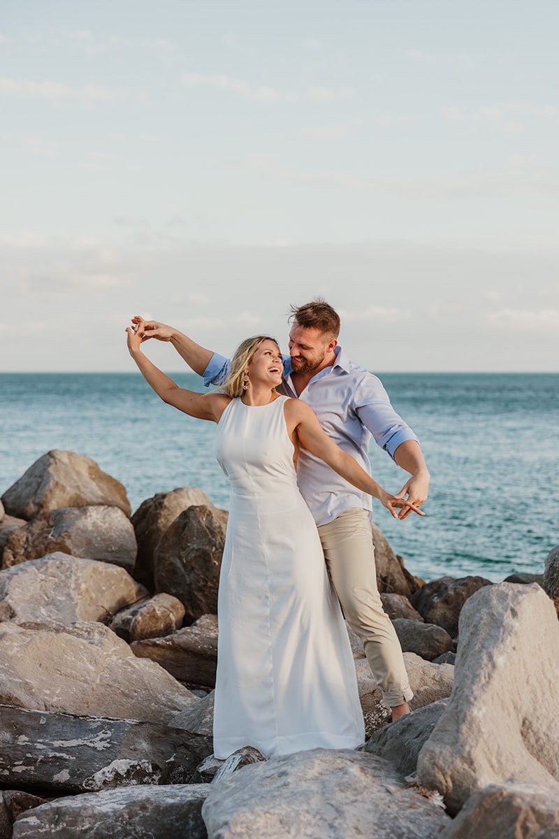 couple, rocks, beach, sand, white dress, dancing