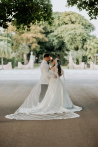 Wedding Photography and Elopement Photography, couple standing together from behind showing the brides long veil