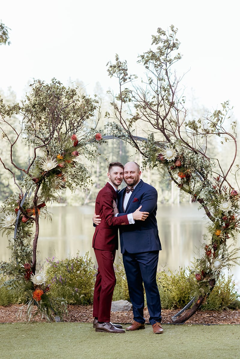 groom and groom, newlyweds, couple, wedding ceremony arch, lord of the rings inspired wedding